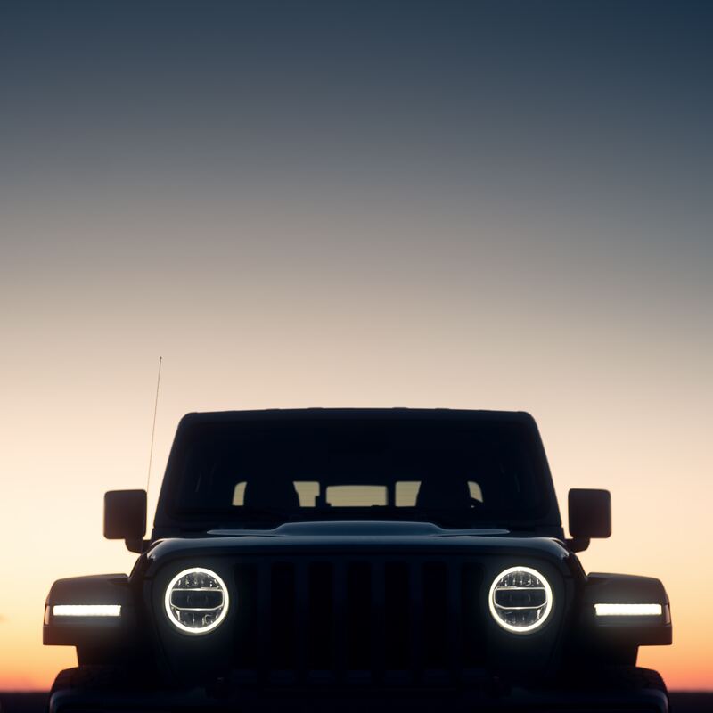 Dark silhouette of the front of a Jeep at dusk with a sunset fading in the background. Links to Auto Apps page (password protected).